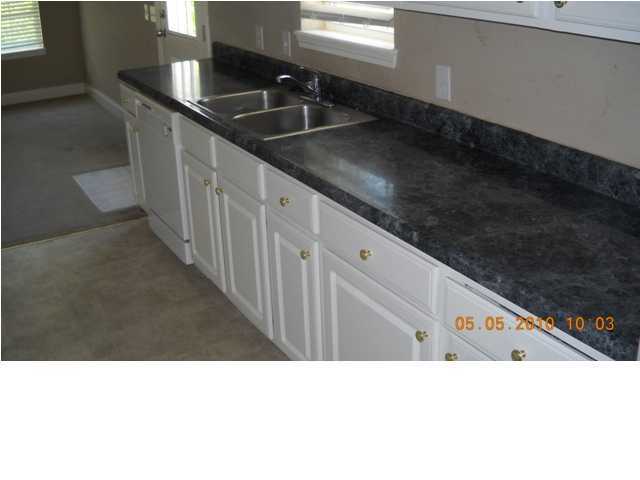 49 Indian Woman Road Santa Rosa Beach, FL 32459 - Photo 3 of 10 a kitchen with granite countertop a sink and a stove