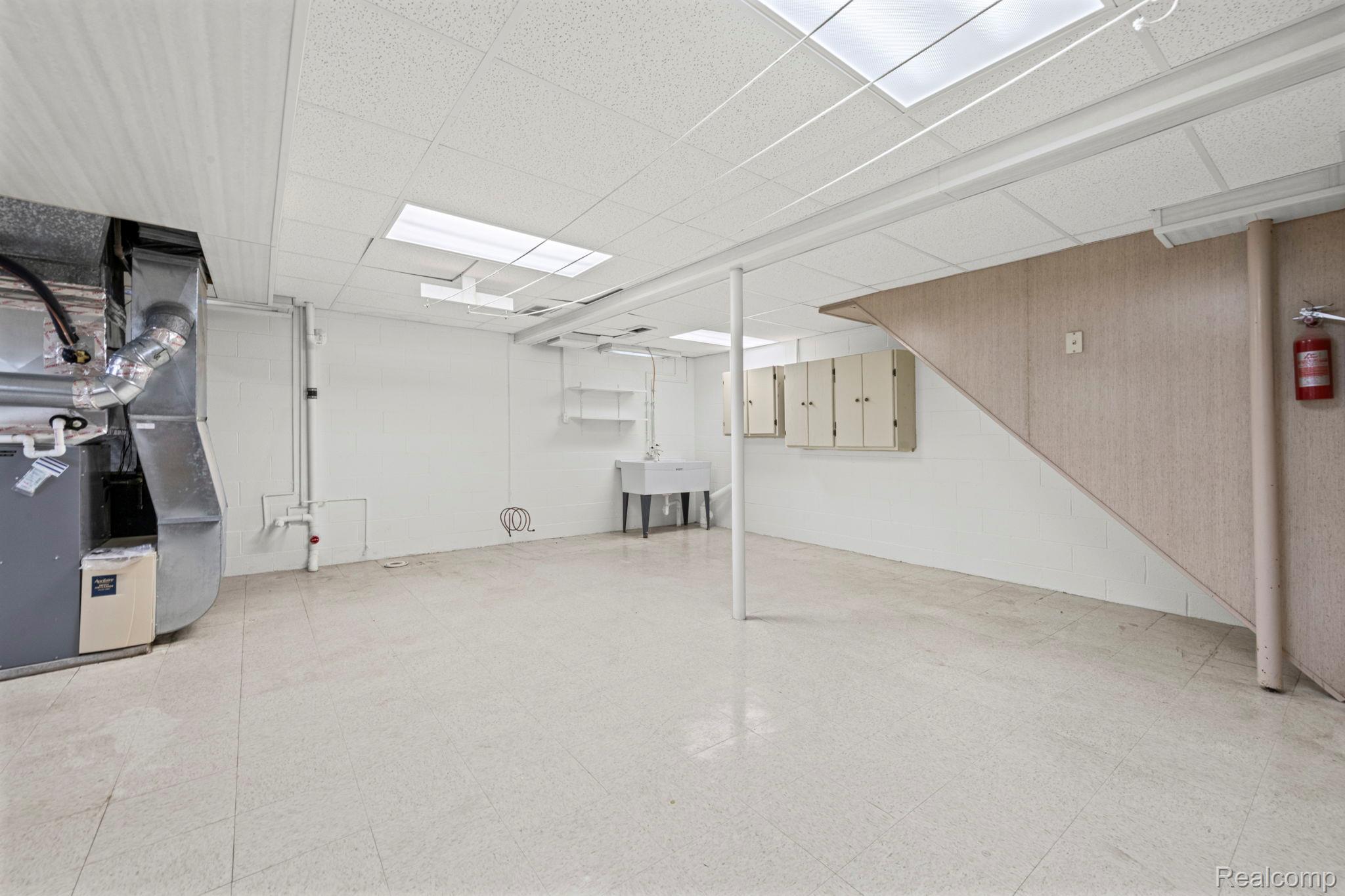 21580 Georgetown Road Trenton, MI 48183 - Photo 29 of 36 Expansive lower level featuring light-toned flooring, white walls, and a drop ceiling with recessed lighting