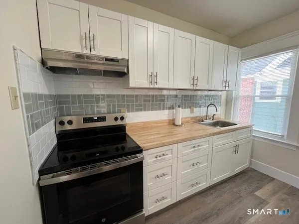 a kitchen with granite countertop cabinets and steel stainless steel appliances