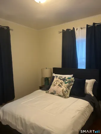 a bedroom with bed and window