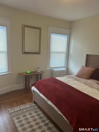 a bedroom with a bed and window