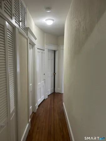 a view of hallway with wooden floor