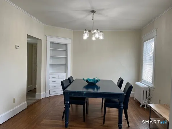 a view of a dining room with a table and chairs