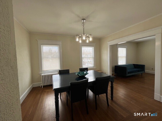 1946 Chapel Street New Haven, CT 06515 - Photo 8 of 23 a dining room with wooden floor a chandelier a wooden table and chairs