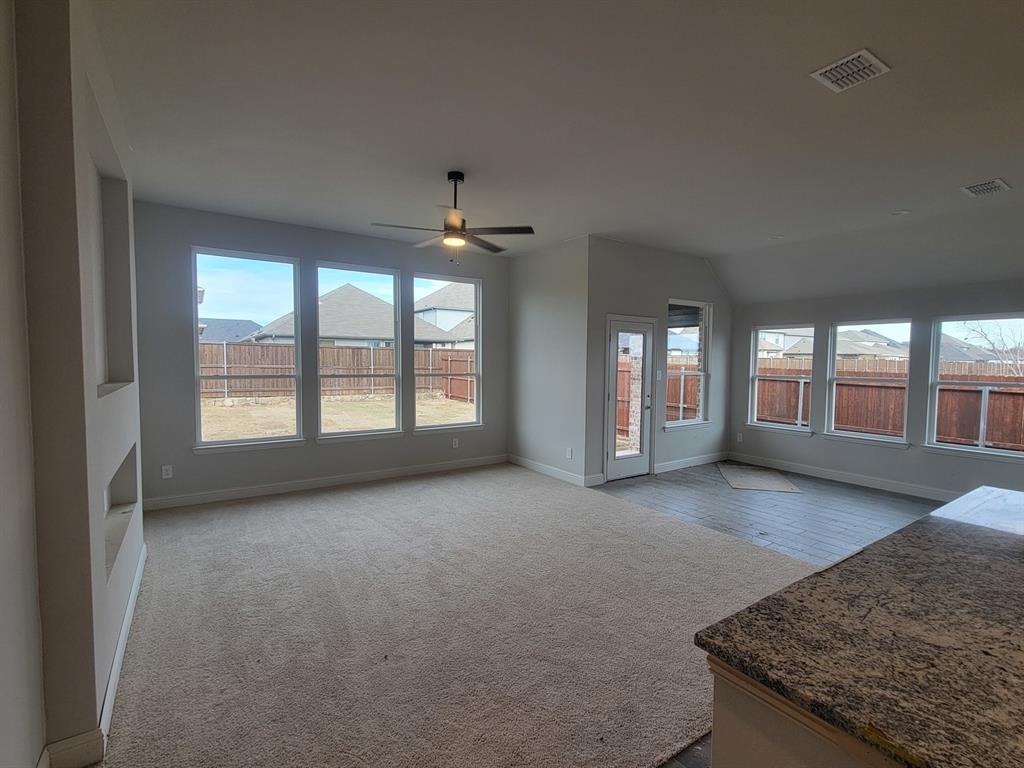 5032 Picasso Road Royse City, TX 75189 - Photo 3 of 15 an empty room with chandelier and windows