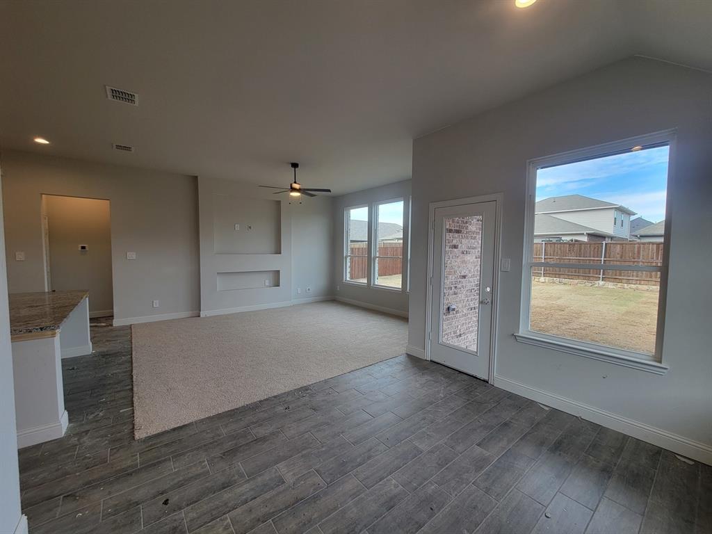 5032 Picasso Road Royse City, TX 75189 - Photo 5 of 15 a view of an empty room with wooden floor and a window