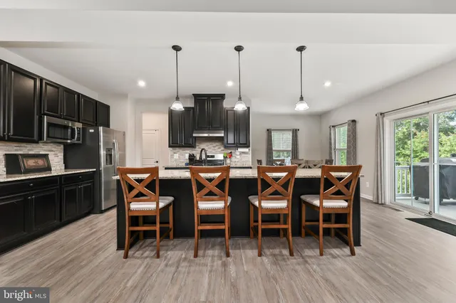 a large kitchen with a table and chairs