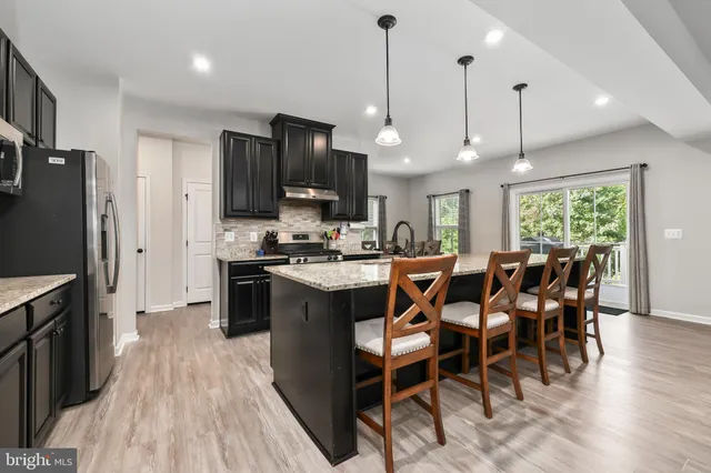 a large kitchen with a table and chairs