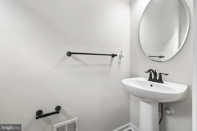 a bathroom with a sink a mirror and vanity