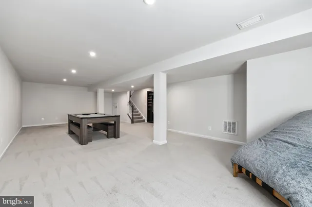 a view of kitchen with furniture and refrigerator