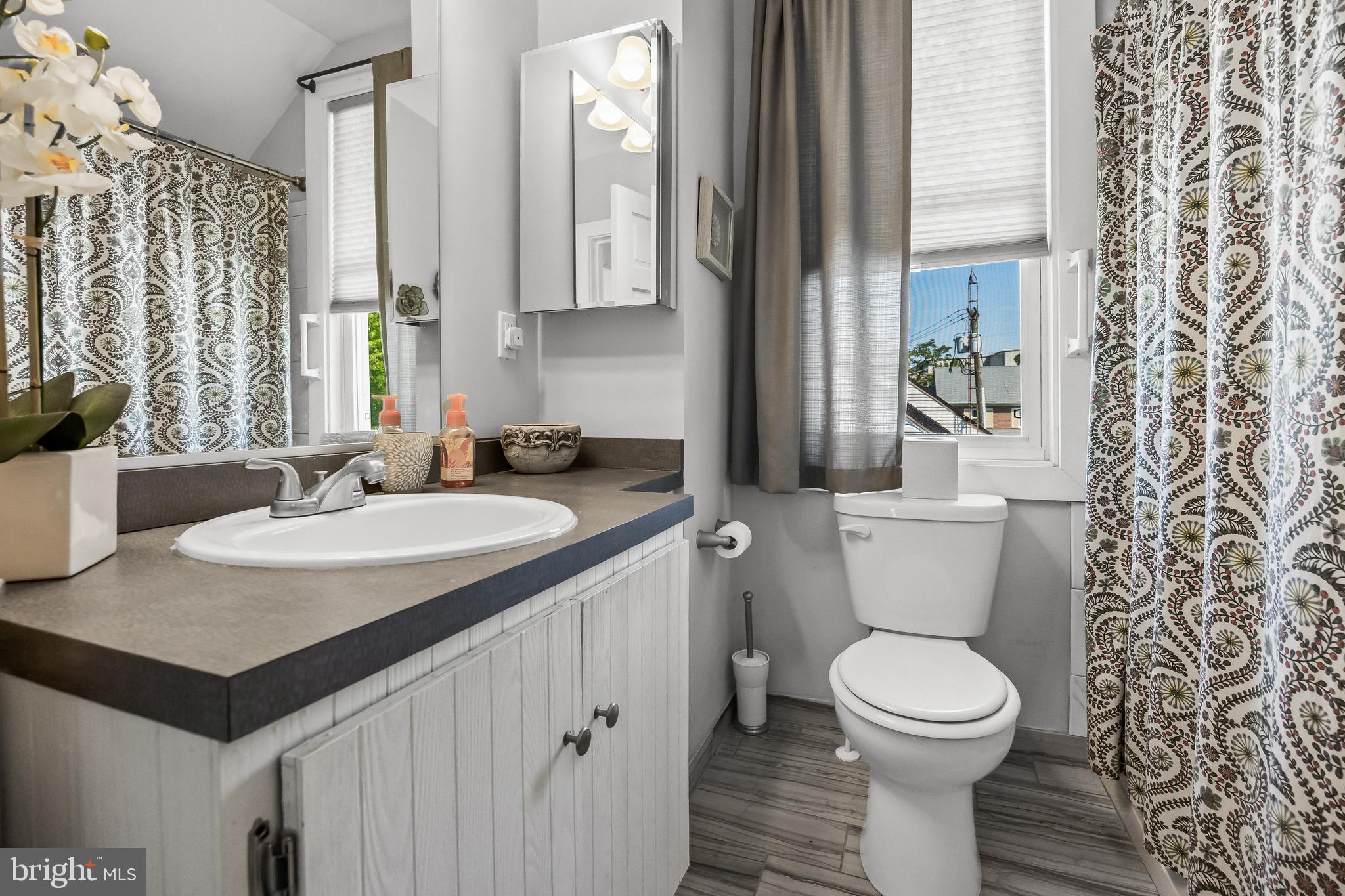 615 North Walnut Avenue Magnolia, NJ 08049 - Photo 25 of 40 a bathroom with a toilet sink and mirror