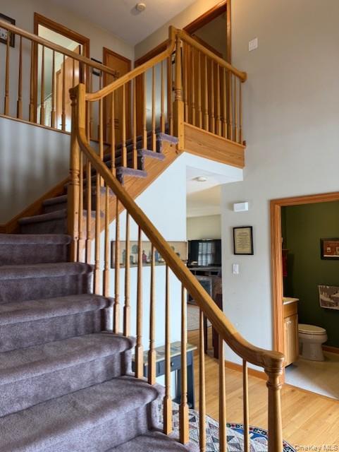 4 Grapevine Place Poughkeepsie, NY 12603 - Photo 15 of 31 a view of staircase with lots of frames on wall and wooden floor