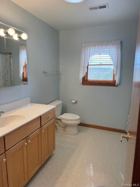 4 Grapevine Place Poughkeepsie, NY 12603 - Photo 26 of 31 a bathroom with a toilet sink and mirror