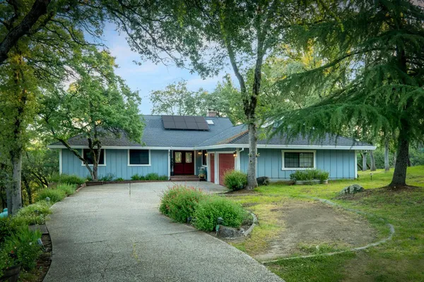 a front view of house with yard and green space