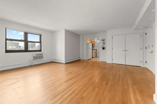 a view of empty room with wooden floor