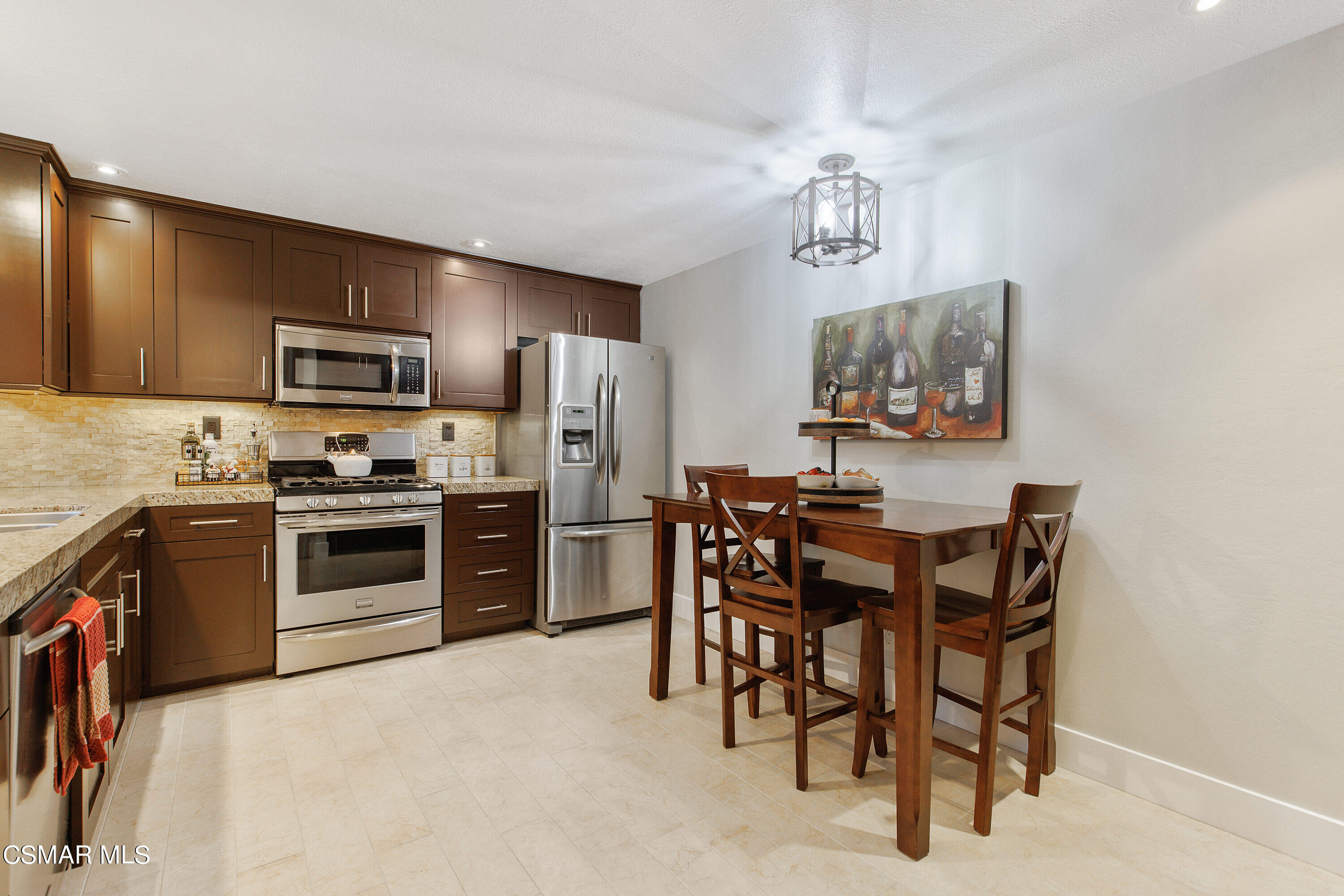 773 Congressional Road Simi Valley, CA 93065 - Photo 16 of 39 a kitchen with stainless steel appliances a refrigerator a stove a sink a table and chairs