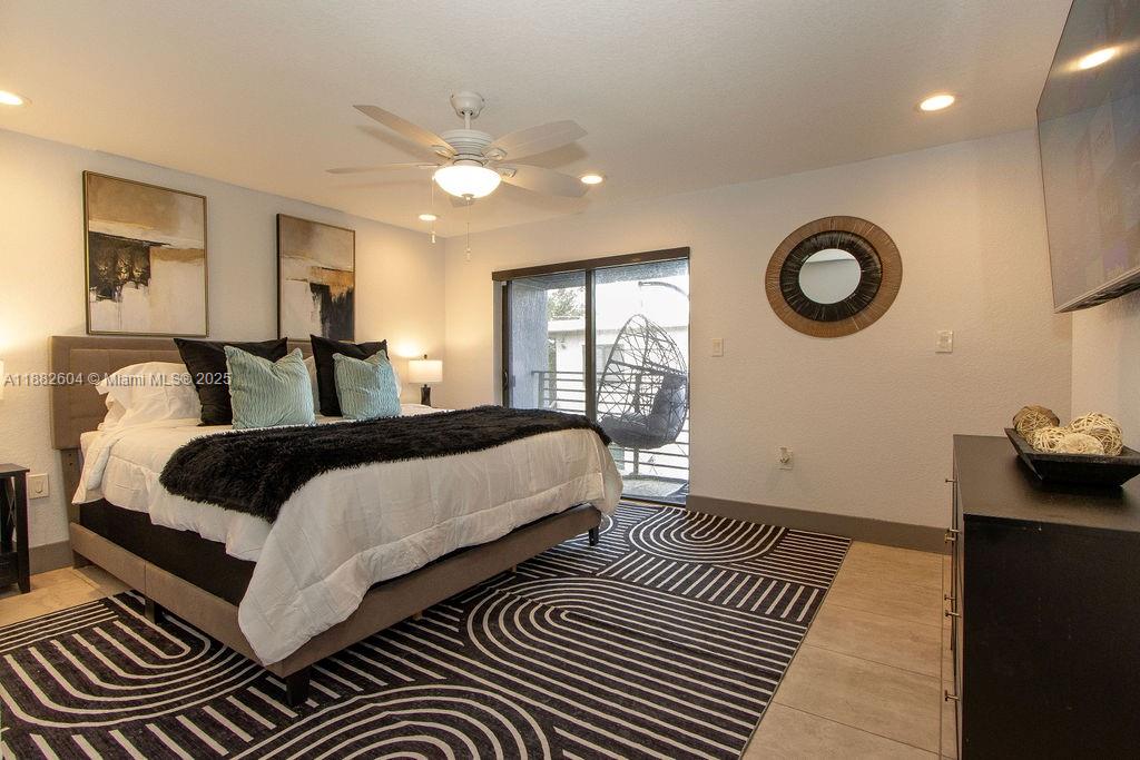 2061 Washington Avenue, Unit 4 Opa-Locka, FL 33054 - Photo 11 of 23 a bedroom with double bed and a window