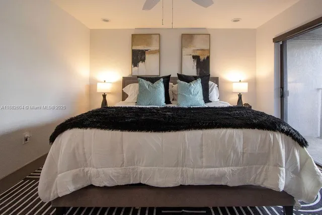 a bedroom with a bed and lamp