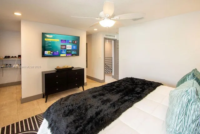 a bedroom with a bed and a flat screen tv