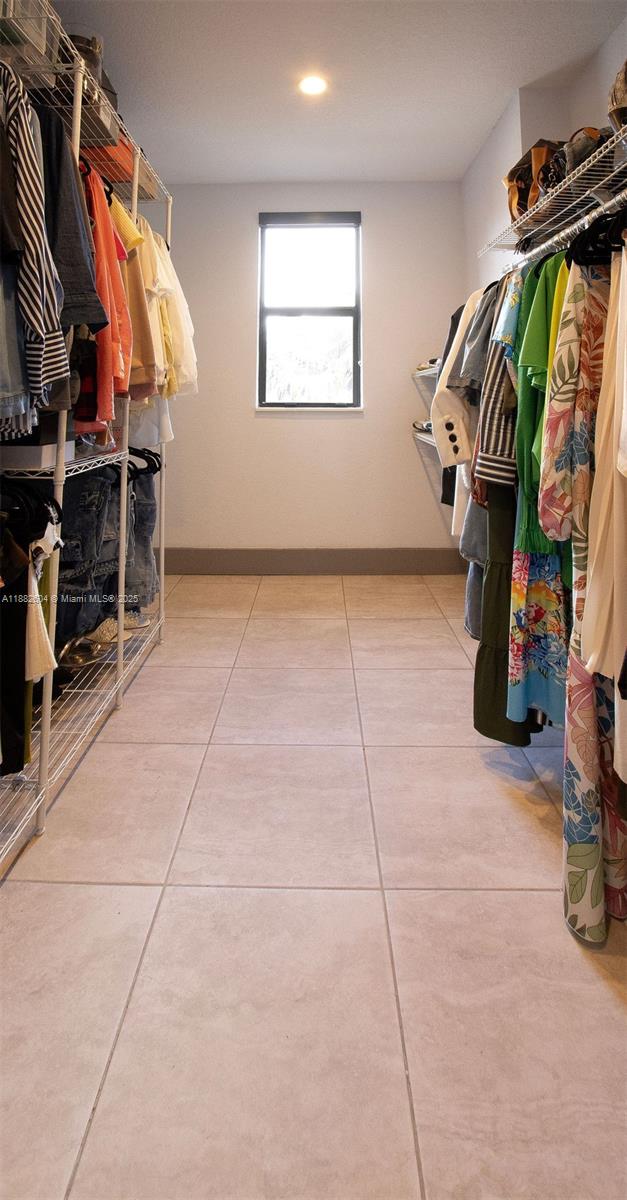 2061 Washington Avenue, Unit 4 Opa-Locka, FL 33054 - Photo 14 of 23 a view of walk in closet with clothes and shoes