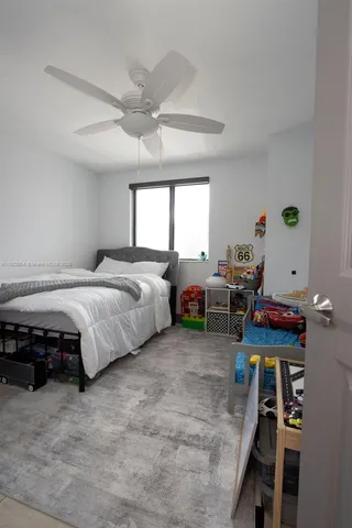 a bedroom with bed and a window