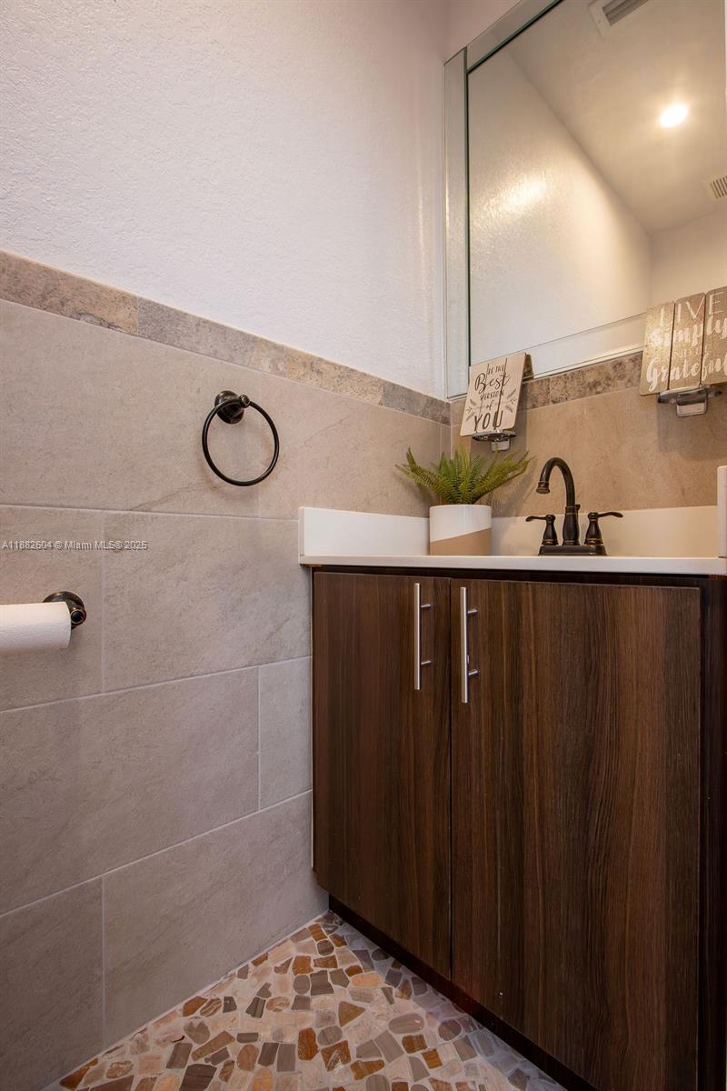 2061 Washington Avenue, Unit 4 Opa-Locka, FL 33054 - Photo 9 of 23 a bathroom with a sink and a mirror