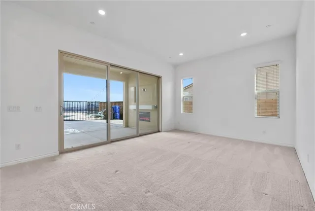 a view of a kitchen with kitchen island a sink stainless steel appliances and cabinets