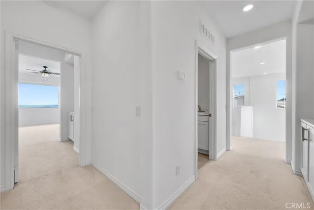 a view of a hallway to closet and cabinet
