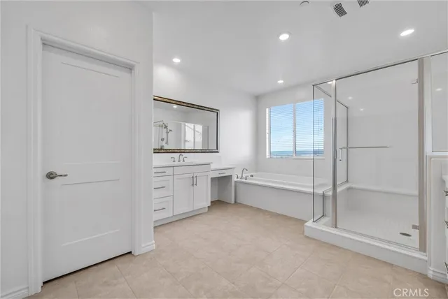 an empty room with a window and a ceiling fan