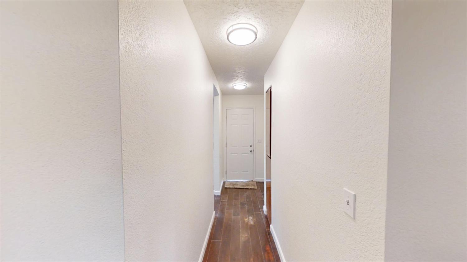 495 Pacific Street Coalinga, CA 93210 - Photo 13 of 33 a view of a hallway with wooden floor
