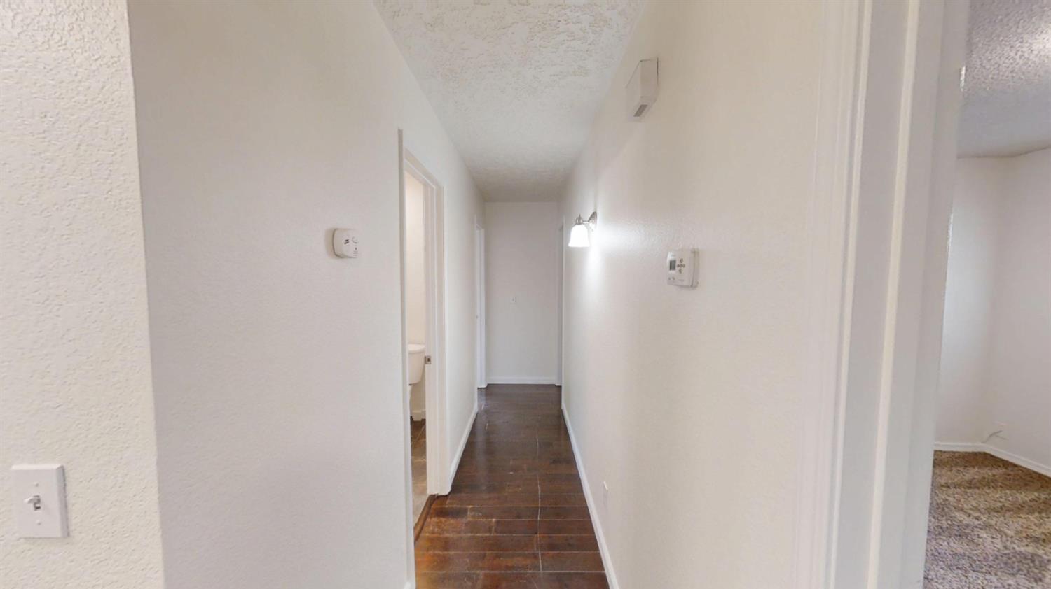 495 Pacific Street Coalinga, CA 93210 - Photo 14 of 33 a view of a hallway with a white walls