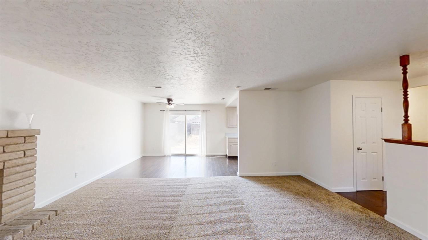 495 Pacific Street Coalinga, CA 93210 - Photo 2 of 33 a view of empty room with wooden floor and fan