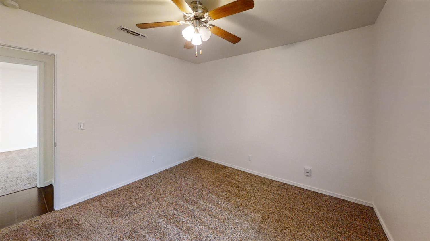 495 Pacific Street Coalinga, CA 93210 - Photo 27 of 33 an empty room with a fan and a fan