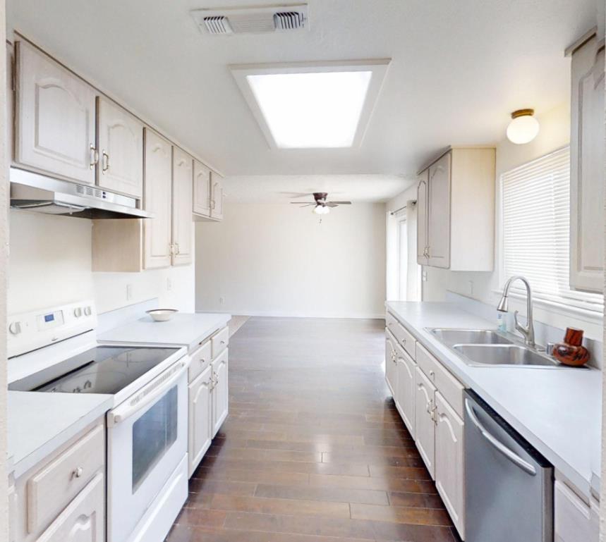 495 Pacific Street Coalinga, CA 93210 - Photo 10 of 33 a kitchen with a sink stove and cabinets