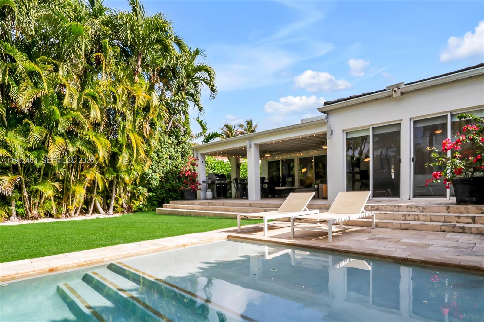 a view of a house with sitting area and garden