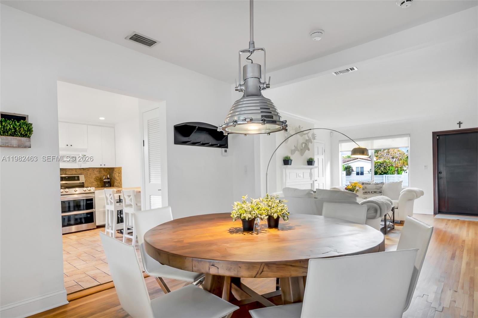540 Southwest 27th Road Miami, FL 33129 - Photo 16 of 54 a dining room with furniture a chandelier and wooden floor