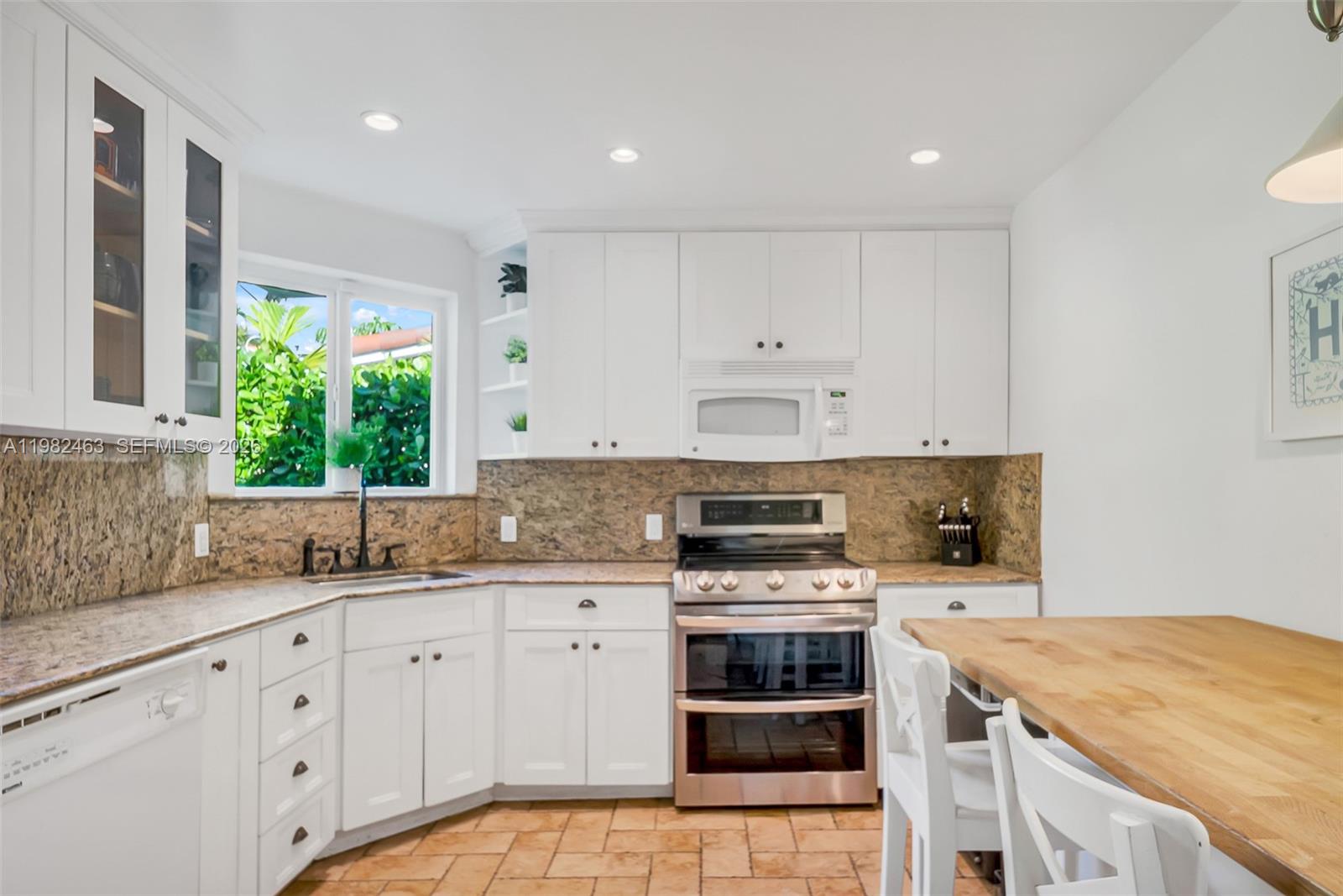 540 Southwest 27th Road Miami, FL 33129 - Photo 17 of 54 a kitchen with a stove a sink and a microwave
