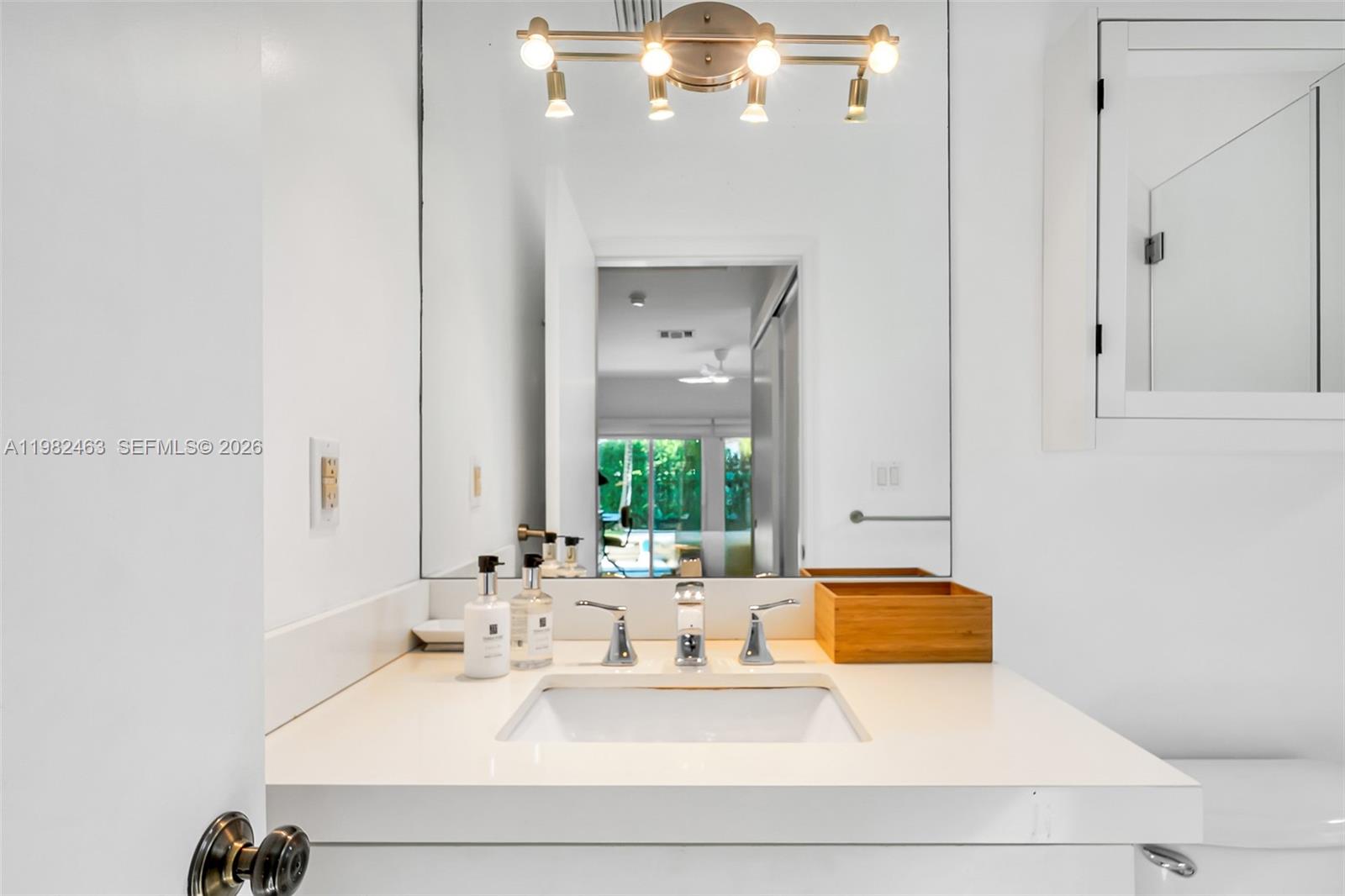 540 Southwest 27th Road Miami, FL 33129 - Photo 29 of 54 a bathroom with a sink vanity and mirror