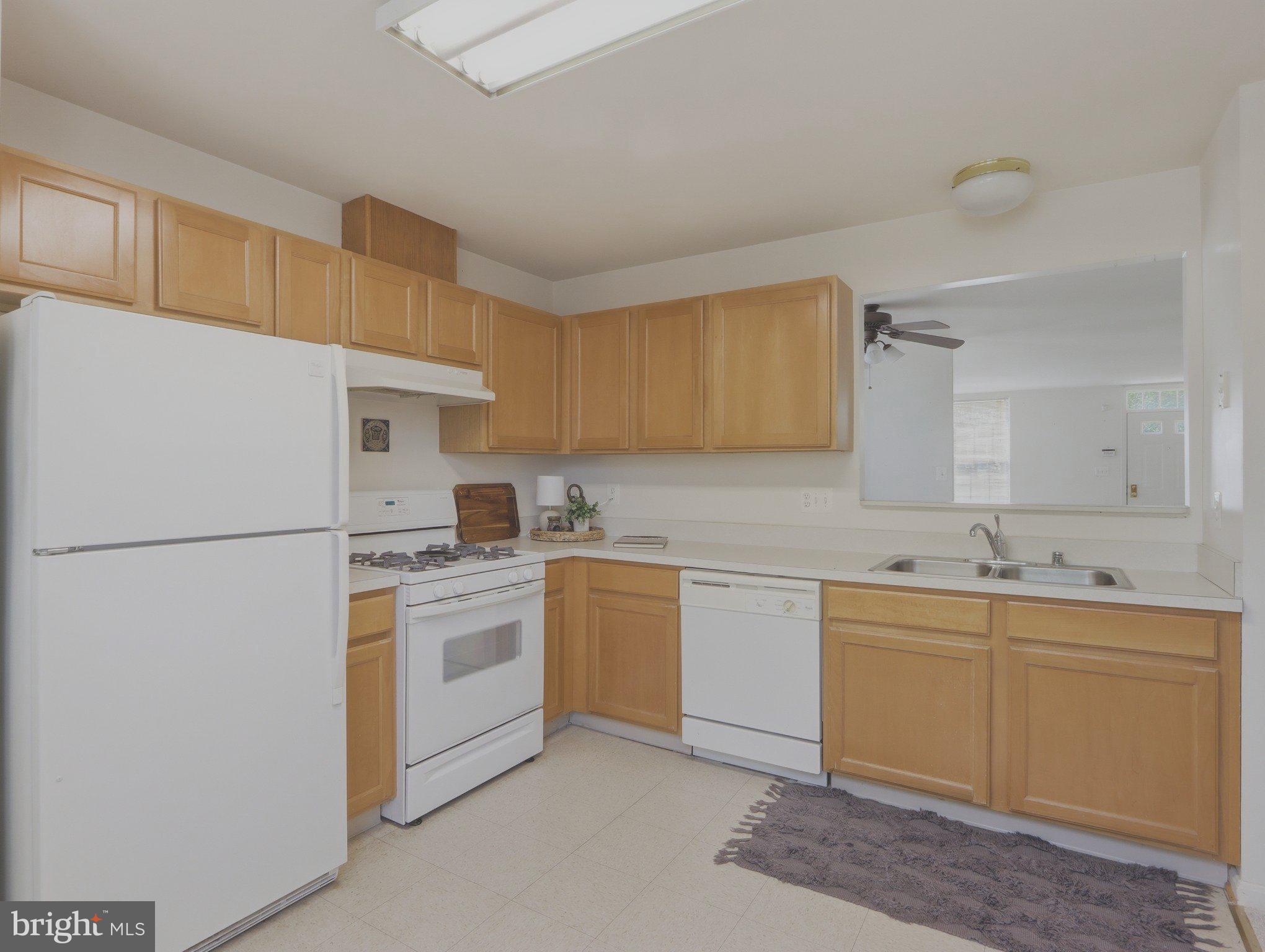 907 Myrtle Avenue Baltimore, MD 21201 - Photo 15 of 28 a kitchen with a sink a stove a refrigerator and cabinets