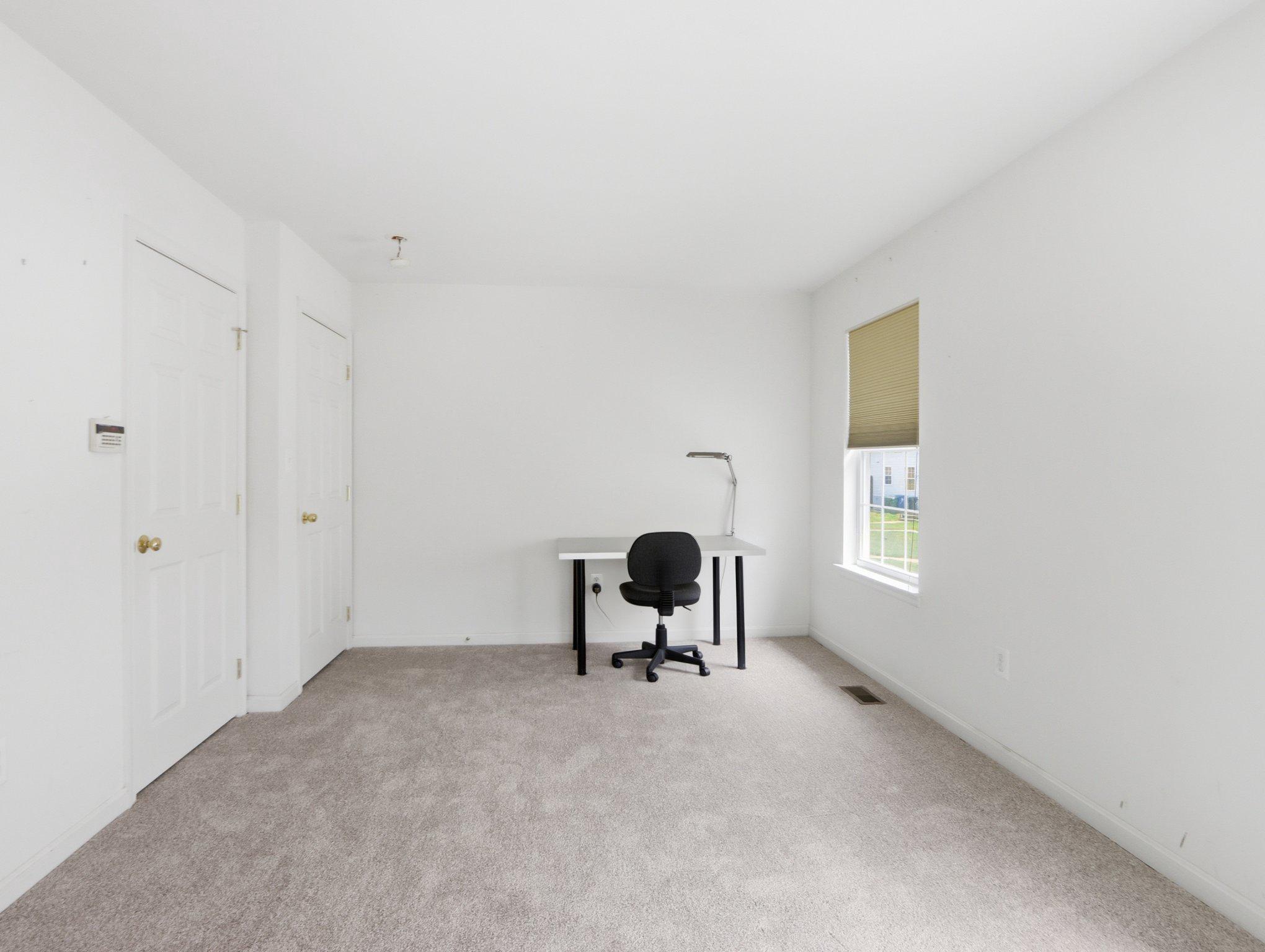 907 Myrtle Avenue Baltimore, MD 21201 - Photo 24 of 28 a room with a window and a chair