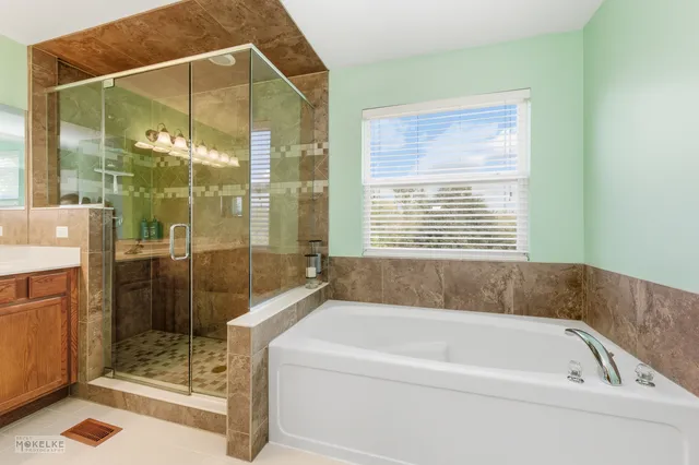 a bathroom with a bathtub and a shower