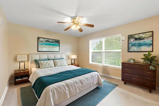 a bedroom with a bed and a window