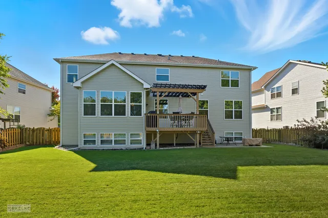 a front view of a house with a yard table and chairs