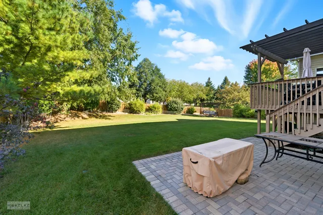 a view of a garden with wooden fence