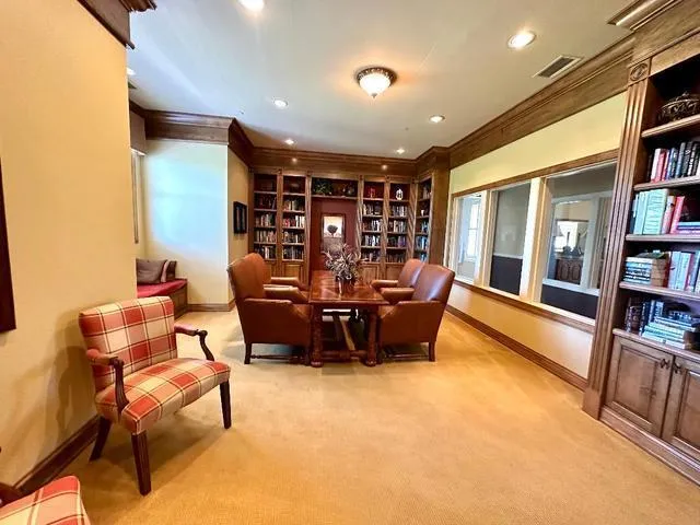a living room with furniture and a book shelf