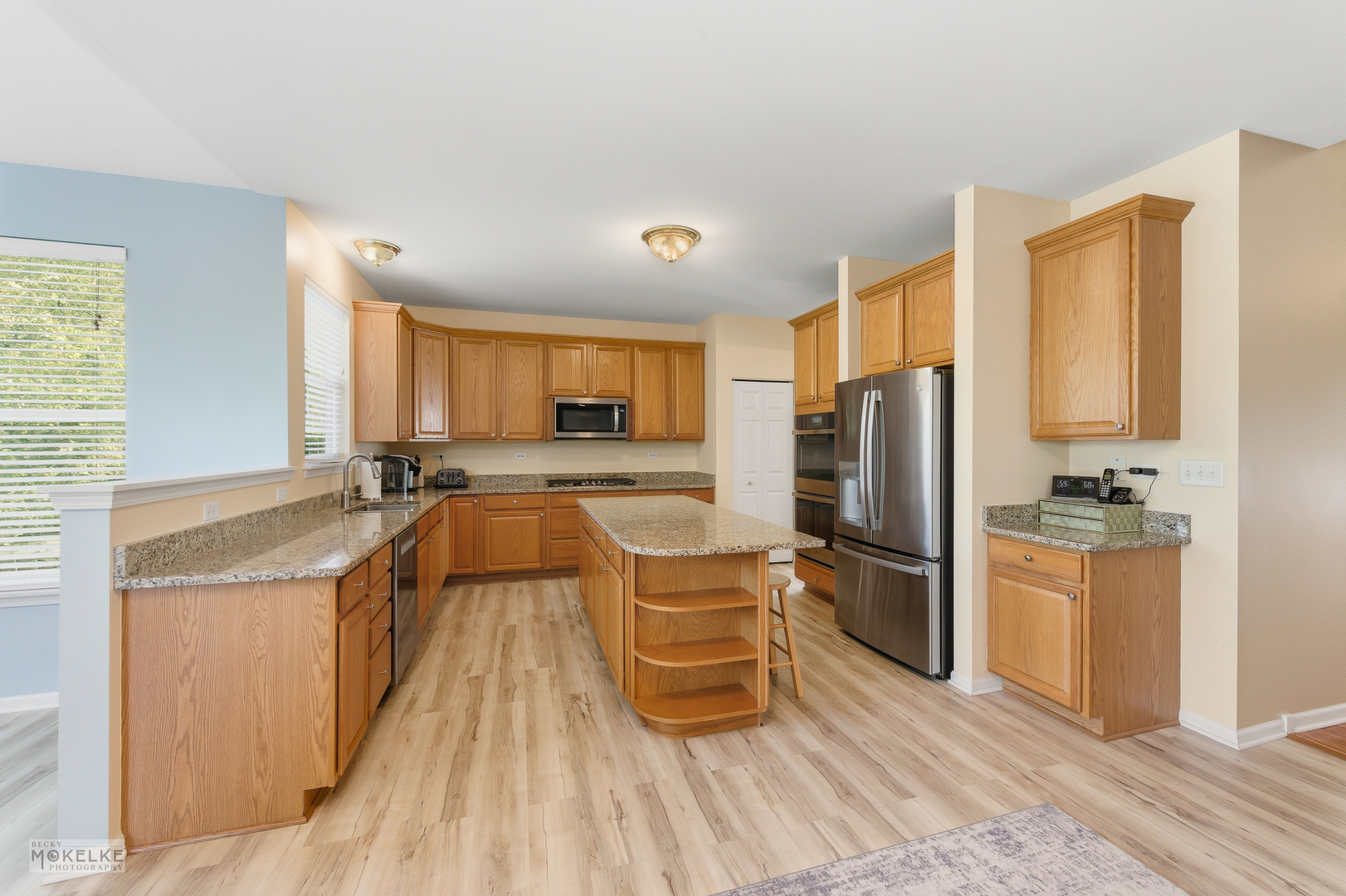 621 Mansfield Way Oswego, IL 60543 - Photo 6 of 37 a kitchen with stainless steel appliances granite countertop a refrigerator a stove and a sink with cabinets