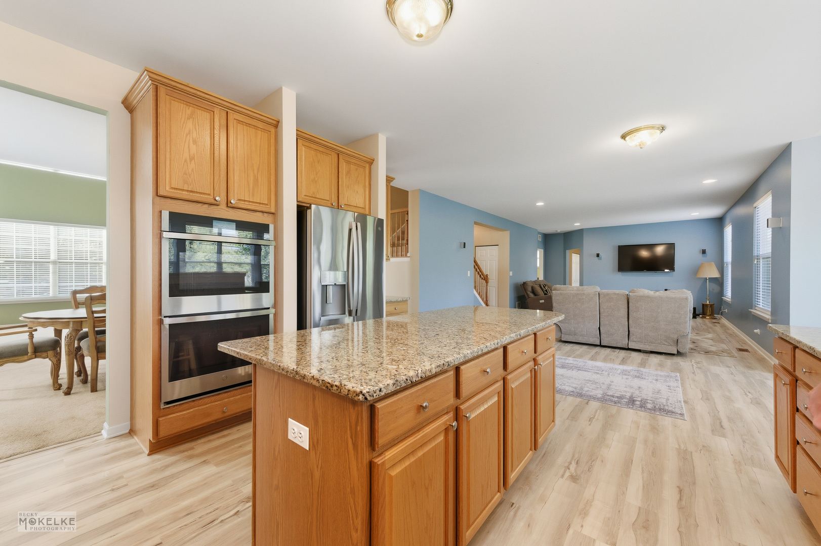 621 Mansfield Way Oswego, IL 60543 - Photo 8 of 37 a kitchen with kitchen island granite countertop wooden floor and a granite counter top