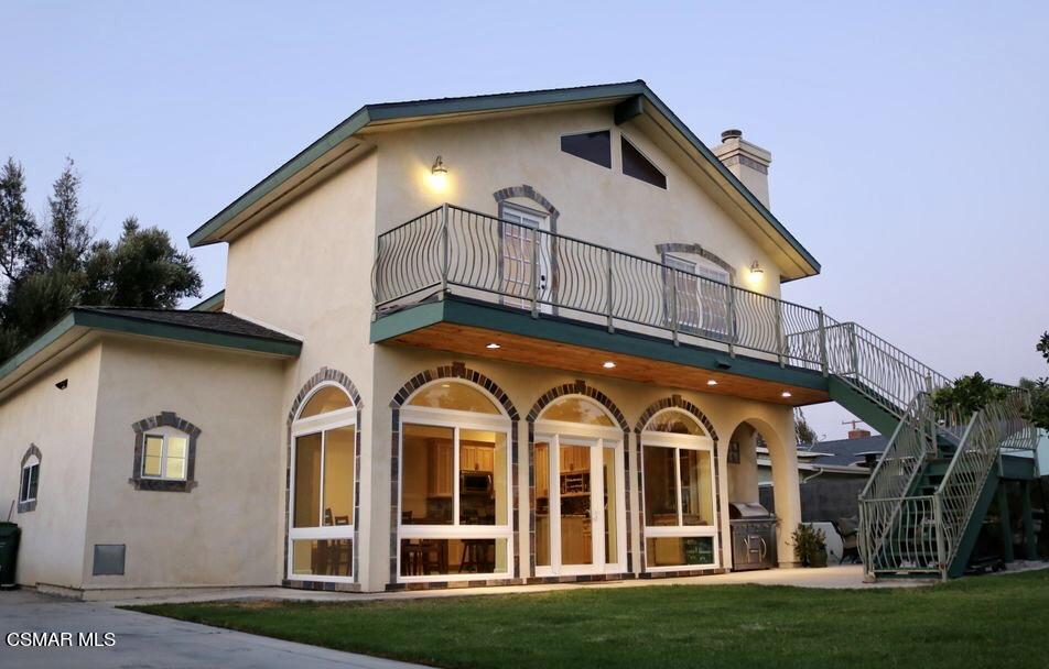 4608 Apricot Road Simi Valley, CA 93063 - Photo 1 of 37 a view of a white house with large windows and a yard with plants