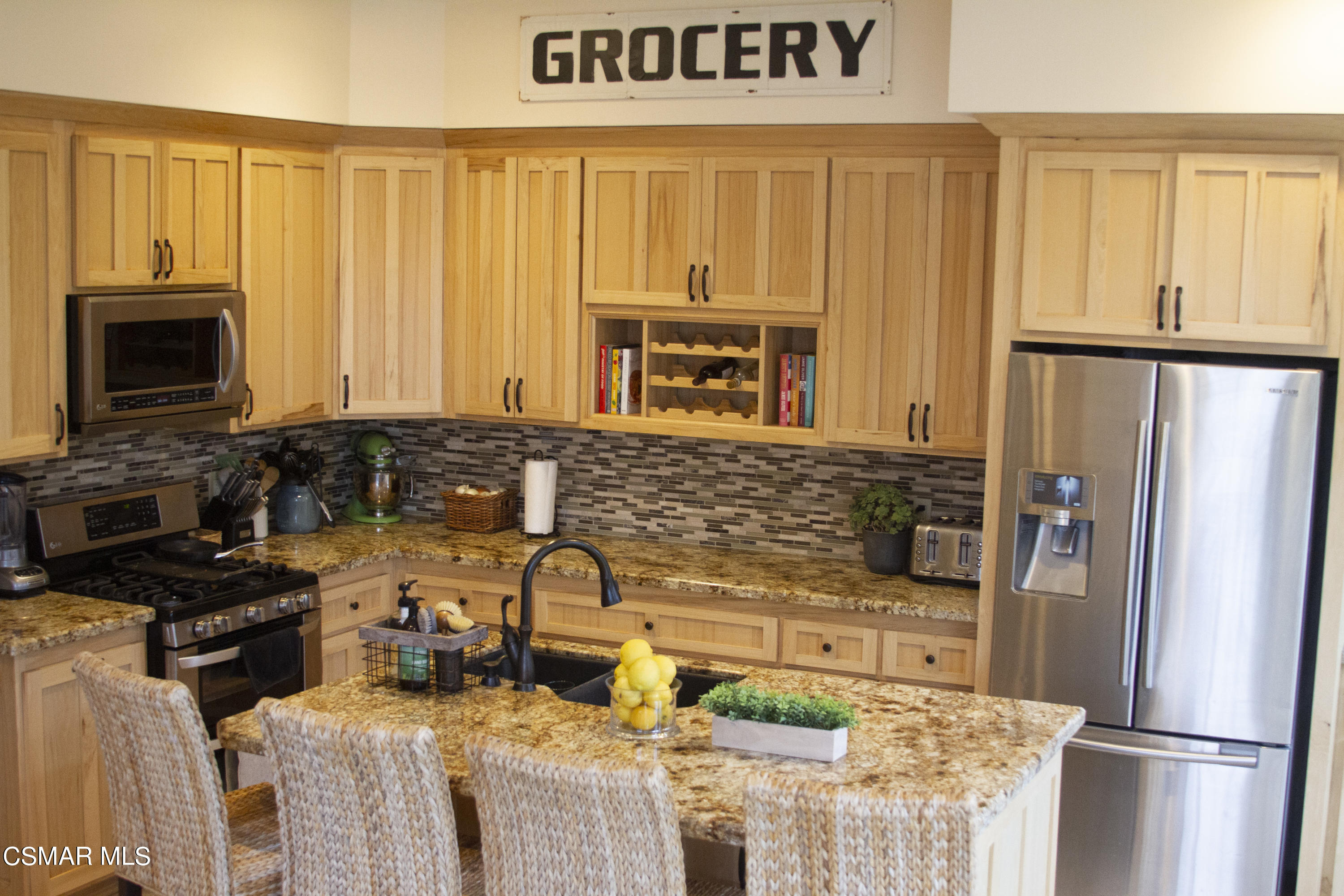 4608 Apricot Road Simi Valley, CA 93063 - Photo 9 of 37 a kitchen with stainless steel appliances a refrigerator a stove a sink and a microwave