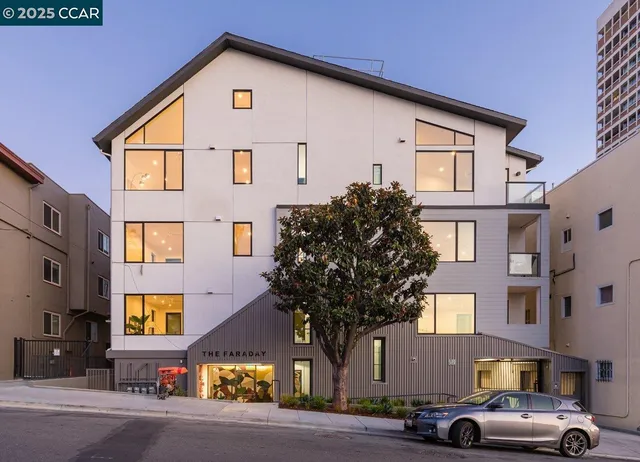 a front view of a residential apartment building with a yard